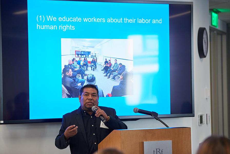 Adrian Ventura of Centro Comunitario de Trabajadores at the podium