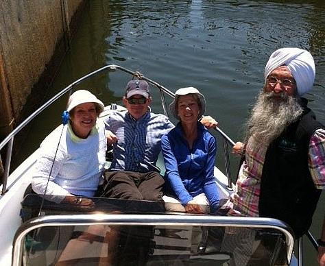 Four people in a boat on the Mystic River